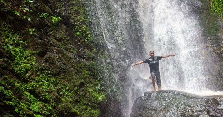 A visitor beneath the Erin Ijesha Waterfall in Osun State