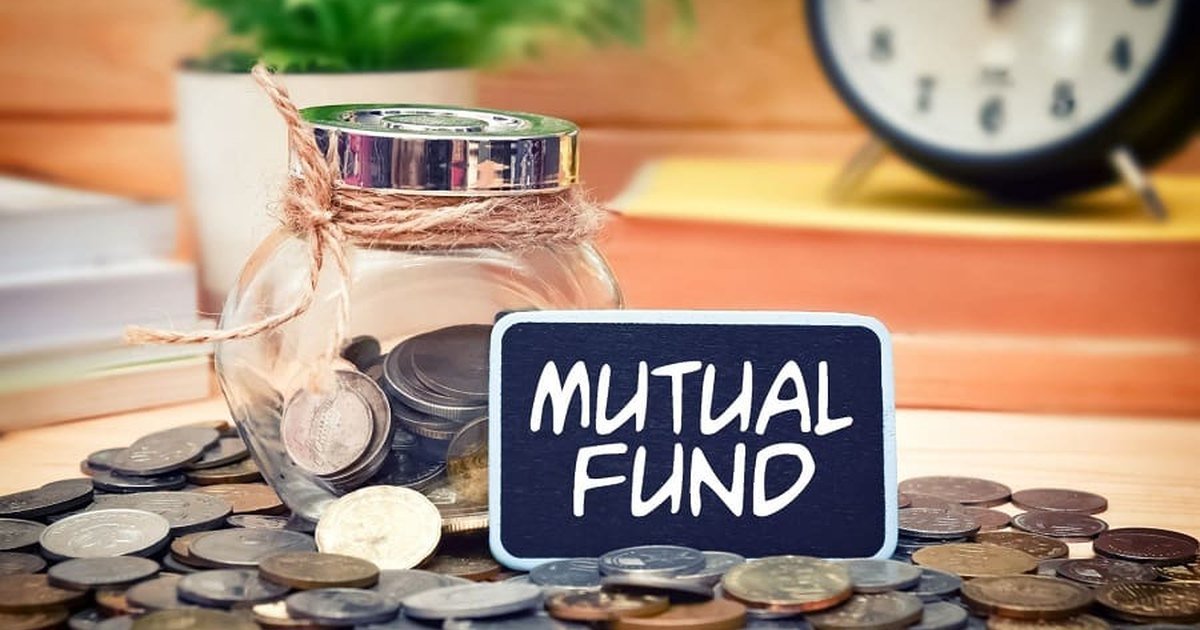 A savings jar and coins beside a mutual fund sign