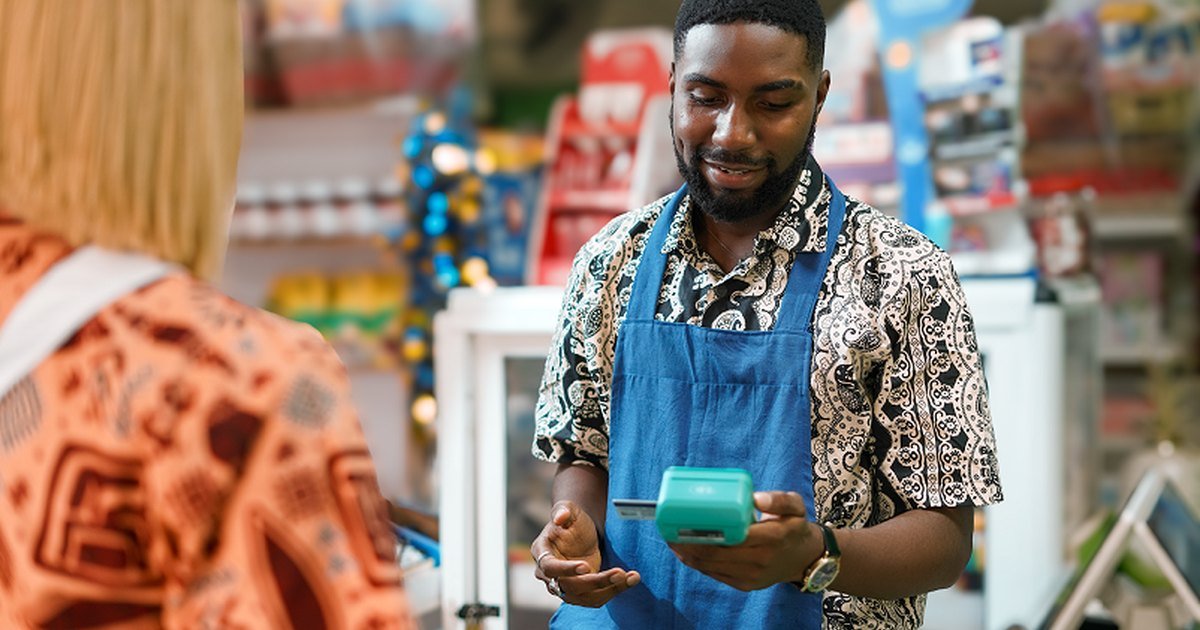 An OPay agent holding a point of sale terminal in Nigeria