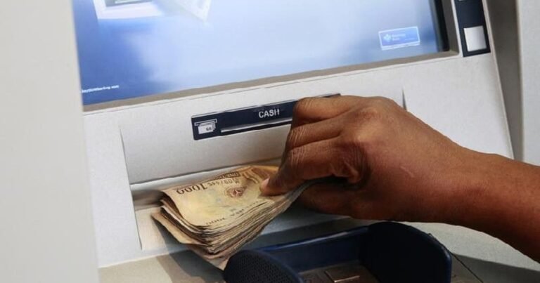 Collecting naira notes from a bank ATM